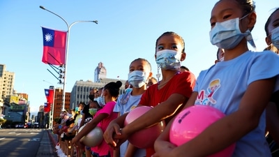 Girls hold balls and they rehearsal ahead of the national day celebration in front of the presidential office in Taipei, Taiwan, October 10, 2021.&nbsp; (Ann Wang / REUTERS)