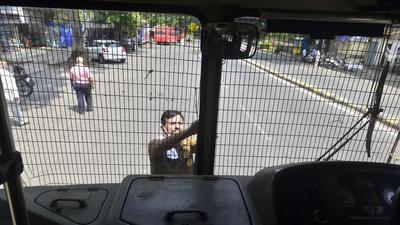 A BEST employee checks the protective net tied to public transport bus as precaution for bandh called by Maharashtra Vikas Aghadi, at Walkeshwar, on Sunday. (Anshuman Poyrekar/HT Photo) A BEST employee checks the protective net tied to public transport bus as precaution for bandh called by Maharashtra Vikas Aghadi, at Walkeshwar, on Sunday. (Anshuman Poyrekar/HT Photo)