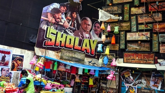 70s’ Bollywood: The pandal has been decorated with hand-painted advertisements, and vintage movie posters and actor cutouts. The theme is ‘Phiria daou tulir tan‘, meaning, ‘give us back the brush stroke.’(PTI)