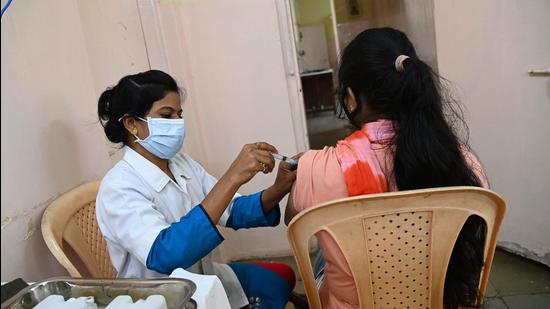 A beneficiary gets a vaccination jab in Pune. As of Sunday, Pune district has reported 450 new Covid-19 cases and one death due to the infection, (HT)