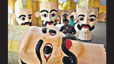 An artiste giving final touches to one of the many heads of demon god Ravana ahead of Dussehra at a temple in Sector 31, Chandigarh, on Monday. (KESHAV SINGH/HT) An artiste giving final touches to one of the many heads of demon god Ravana ahead of Dussehra at a temple in Sector 31, Chandigarh, on Monday. (KESHAV SINGH/HT)