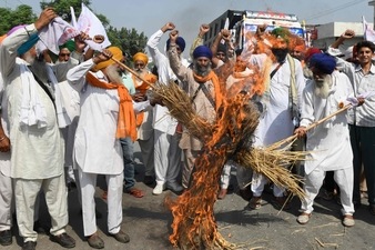 Farmers shout slogans against the three farm laws (AFP) Farmers shout slogans against the three farm laws (AFP)