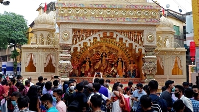 Devotees take pictures of a puja pandal ahead of the Durga puja festival, in Kolkata on Sunday. (ANI Photo) Devotees take pictures of a puja pandal ahead of the Durga puja festival, in Kolkata on Sunday. (ANI Photo)