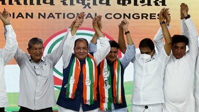 Uttarakhand minister and senior BJP leader Yashpal Arya and his son BJP MLA Sanjeev Arya join Congress party. (ANI Photo)