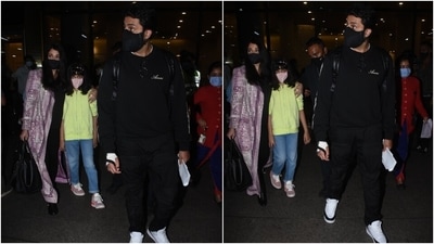 Abhishek was snapped outside the airport with his family in a black crewneck sweatshirt, which he teamed with matching joggers and a black face mask. The actor completed his airport look with white chunky lace-up sneakers. (HT Photo/Varinder Chawla)