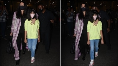 As for Aishwarya, she looked stunning in a solid black blouse and matching tights. She added a dash of colour to her look with a lavender embroidered long jacket. Black leather boots, a face mask, and a top handle bag completed her airport outfit. (HT Photo/Varinder Chawla)