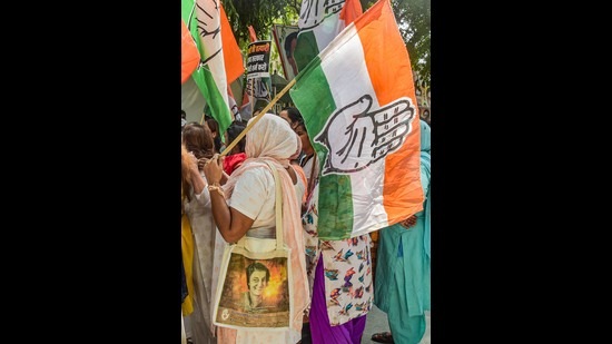 Delhi Pradesh Congress Committee activists hold party flags (PTI)