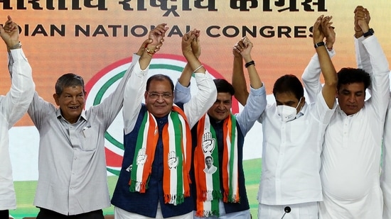 Uttarakhand minister and senior BJP leader Yashpal Arya and his son BJP MLA Sanjeev Arya join Congress party.(ANI Photo)