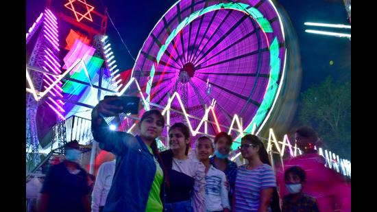 City residents enjoying the mela ahead of Dussehra festival at Daresi ground in Ludhiana on Monday. (Gurpreet Singh/HT)