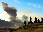 Northern Alliance soldiers watch as US air strikes attack Taliban positions in Kunduz province, Afghanistan. Northern Alliance soldiers watch as US air strikes attack Taliban positions in Kunduz province, Afghanistan.