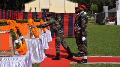 An Indian Army officer laying wreath on the coffin of one of the soldiers, who were killed in action in Poonch during a counterterrorist operation, in Rajouri on Tuesday. (HT Photo)
