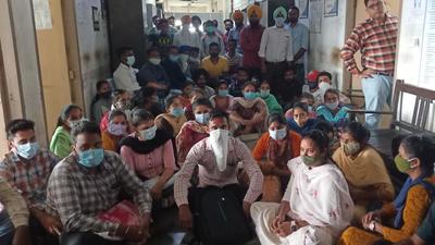 Newly appointed health workers and librarians holding a protest outside the civil surgeon’s office in Sangrur on Tuesday. (HT Photo)