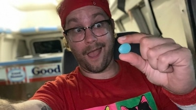 The image shows the man holding the blue rock he received from the girl for the ice cream. (Twitter/@AndrewHilaryUS) The image shows the man holding the blue rock he received from the girl for the ice cream. (Twitter/@AndrewHilaryUS)