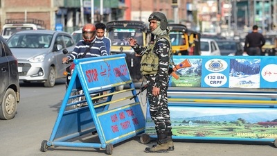 A security personnel stands guard at a check point, in Srinagar on Monday. (PTI Photo) A security personnel stands guard at a check point, in Srinagar on Monday. (PTI Photo)