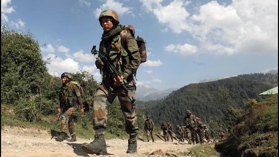 Security personnel patrol near the encounter site in Rajouri sector of Jammu and Kashmir on Tuesday. (ANI)