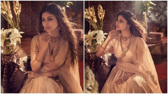 Styled by fashion stylist Maneka Hari Singhani, Mouni chose to leave her long tresses open in soft curls around her shoulders. Mouni accessorised her look for the day with traditional gold statement earrings, rings, bangles, choker and a necklace. The jewellery is designed by Anmol Jewellers.(Instagram/@imouniroy)