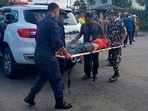Police and army personnel carry an injured passenger to a hospital in Nepalgunj, some 650 km west of Kathmandu on October 12, 2021, after being airlifted from the Mugu region. (AFP) Police and army personnel carry an injured passenger to a hospital in Nepalgunj, some 650 km west of Kathmandu on October 12, 2021, after being airlifted from the Mugu region. (AFP)
