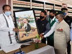 Vice President M Venkaiah Naidu receives an artwork from the speaker of Arunachal Pradesh Assembly Pasang Dorjee Sona, depicting Naidu in Memba traditional attire, on Saturday.(PTI)