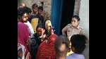 A woman cop and locals at the crime scene in trans-Yamuna region of Prayagraj. (HT) A woman cop and locals at the crime scene in trans-Yamuna region of Prayagraj. (HT)