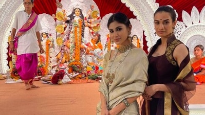 Mouni Roy shared pictures of herself celebrating Maha Ashtami. The Gold actor looked stunning in a golden saree which she teamed with a golden blouse and statement jewellery. (Instagram/@imouniroy)