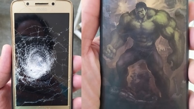 The photos, posted by the man's physician Dr Pedro Carvalho, show that the bullet indeed hit the Motorola smartphone, shattering its screen, but was ultimately stopped by the Incredible Hulk-themed cover.&nbsp; (Photo via @Oparbento1 on Twitter)