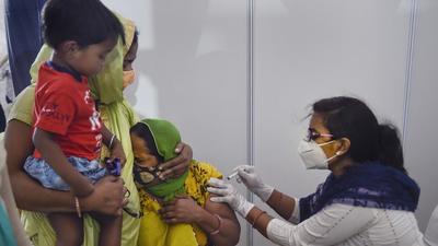 A health worker administers Covid vaccine dose to a beneficiary in New Delhi. Union health minister Mansukh Mandaviya said India will administer 1 billion doses by third week of October. (PTI) A health worker administers Covid vaccine dose to a beneficiary in New Delhi. Union health minister Mansukh Mandaviya said India will administer 1 billion doses by third week of October. (PTI)