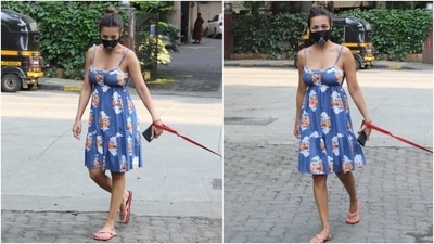 Malaika teamed her ensemble with a black printed face mask to keep herself safe during the pandemic and a pair of pink flip flops. She tied her locks in a sleek bun and went for a bare face to round it off. (HT Photo/Varinder Chawla)