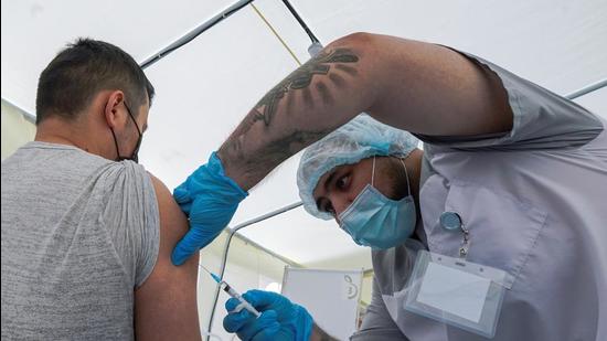 A worker receives a jab while being injected with the one-dose Sputnik Light vaccine in Moscow on June 30. According to RDIF, Sputnik Light shows 70% efficacy against Delta variant of the SARS-COV-2 virus. (REUTERS) A worker receives a jab while being injected with the one-dose Sputnik Light vaccine in Moscow on June 30. According to RDIF, Sputnik Light shows 70% efficacy against Delta variant of the SARS-COV-2 virus. (REUTERS)