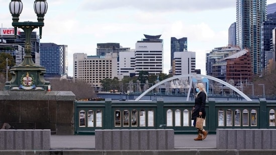 A lone woman, wearing a protective face mask, walks across a city centre bridge as the state of Victoria looks to curb the spread of a coronavirus disease (COVID-19) outbreak in Melbourne, Australia(REUTERS) A lone woman, wearing a protective face mask, walks across a city centre bridge as the state of Victoria looks to curb the spread of a coronavirus disease (COVID-19) outbreak in Melbourne, Australia(REUTERS)