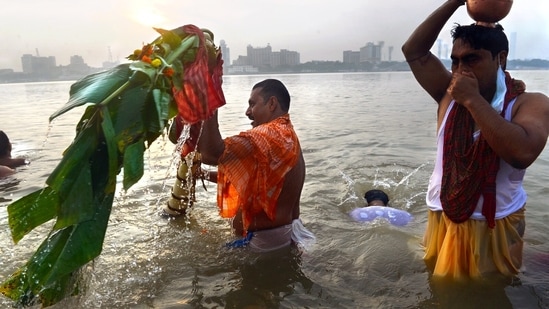 Devotees perform the ritual of 'Kola Bou Snan,' where a banana tree is given a dip in the river Ganga, on the occasion of Maha Saptami of Durga Puja festival in Kolkata on October 12.(ANI)