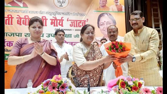 Baby Rani Maurya being welcomed at a function organised by BJP’s SC wing in Lucknow with Maurya’s ‘Jatav’ Dalit subcaste prominently showcased in the backdrop . (HT)