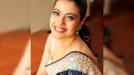 On the occasion of Maha Ashtami, Kajol took to her Instagram handle to treat her fans with a picture of herself in a gorgeous royal blue saree which she teamed with a golden sequins blouse.(Instagram/@kajol)