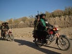 Taliban fighters patrol along a road on motorbikes at Ghasabha area in Qala-e-Now, Badghis province Taliban fighters patrol along a road on motorbikes at Ghasabha area in Qala-e-Now, Badghis province