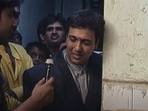 Govinda talking to a reporter in his childhood home.
