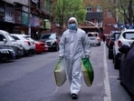 A man wearing a protective suit is seen on a street in Wuhan, Hubei province, the epicentre of China's coronavirus disease.(Reuters Photo) A man wearing a protective suit is seen on a street in Wuhan, Hubei province, the epicentre of China's coronavirus disease.(Reuters Photo)