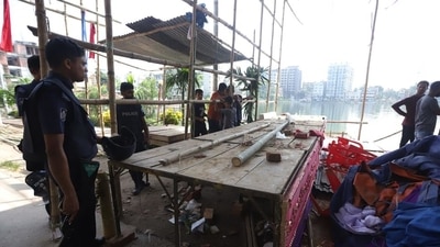 Police stand guard next to a vandalised temporary place of worship set up on the occasion of Durga Puja festival in Comilla on October 14, after hundreds vandalised several Hindu temples across the Muslim-majority country following furore over footage of a Quran being placed on the knee of a figure of the Hindu god Hanuman during a religious festival. ( AFP) Police stand guard next to a vandalised temporary place of worship set up on the occasion of Durga Puja festival in Comilla on October 14, after hundreds vandalised several Hindu temples across the Muslim-majority country following furore over footage of a Quran being placed on the knee of a figure of the Hindu god Hanuman during a religious festival. ( AFP)
