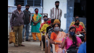 People wait to receive the vaccine for COVID-19 at a vaccination center set up at a government run school in Bengaluru (AP)