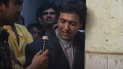 Govinda talking to a reporter in his childhood home.