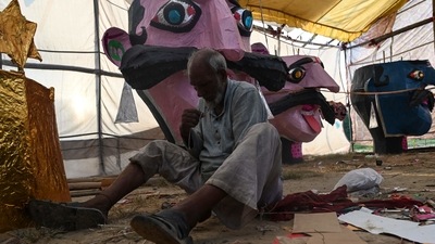 An artisan works on an effigy depicting demon king Ravana ahead of the Dussehra festival celebrations in New Delhi in October 13. (AFP) An artisan works on an effigy depicting demon king Ravana ahead of the Dussehra festival celebrations in New Delhi in October 13. (AFP)