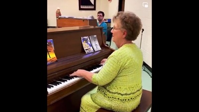 Woman plays a beautiful tune on piano with full gusto. Screengrab Woman plays a beautiful tune on piano with full gusto. Screengrab