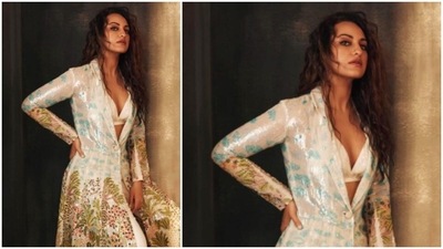 In this picture, the gorgeous Sonakshi Sinha can be seen posing in a white glossy bralette which she teamed with a long printed jacket and trousers. (Instagram/@aslisona)