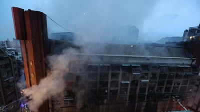Smoke from an overnight fire rises from a building in the southern Taiwanese city of Kaohsiung on October 14, 2021. (AFP)