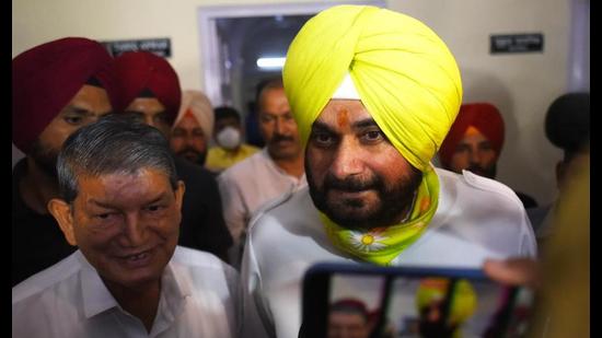 Punjab Congress chief Navjot Singh Sidhu leaves after meeting party leaders KC Venugopal (not in pic) and Harish Rawat (L) at the All India Congress Committee headquarters in New Delhi on Thursday. (Amal KS/HT)