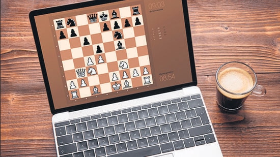 Premium Photo  Woman playing chess online uses laptop