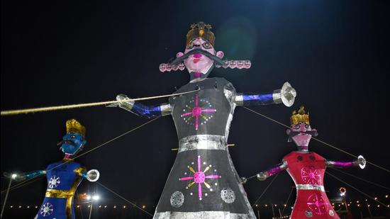 On Dussehra, effigies of Ravana, Meghnad and Kumbhkarna are burnt in public spaces as a symbolic gesture to mark the victory of good over evil. The annual festival is celebrated across the city – in open grounds, marketplaces and parks. (Sanchit Khanna/HT Photo)