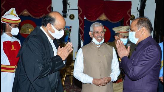 Himachal Pradesh chief minister Jai Ram Thakur greets Himachal chief justice Mohmmad Rafiq in Shimla on Thursday. (Deepak Sansta / HT)
