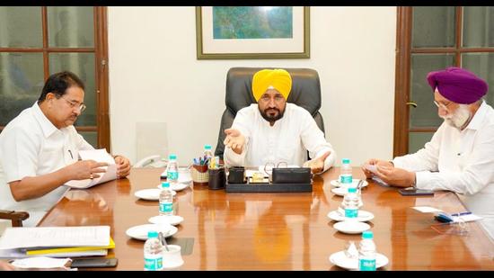 Chief minister Charanjit Singh Channi flanked by his deputies OP Soni and Sukhjinder Singh Randhawa in Chandigarh. The CM convened a meeting with all DCs of Punjab on Thursday and asked them to focus on people-centric works. (HT file photo)