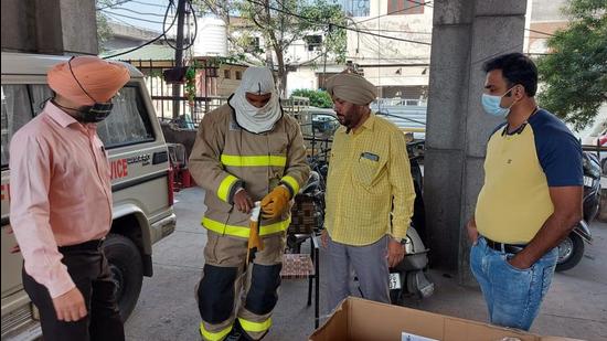 Firemen of the Ludhiana fire department during a demo of the proximity suits. (HT Photo)