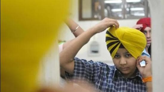 After a few minutes of hopeful patience, we called him to discover that he was still tying his ‘pagg’. Parents with young turbanators at home must have guessed that our movie plan was running into rough weather. (Representative photo) After a few minutes of hopeful patience, we called him to discover that he was still tying his ‘pagg’. Parents with young turbanators at home must have guessed that our movie plan was running into rough weather. (Representative photo)