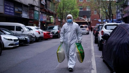 A man wearing a protective suit is seen on a street in Wuhan, Hubei province, the epicentre of China's coronavirus disease.(Reuters Photo) A man wearing a protective suit is seen on a street in Wuhan, Hubei province, the epicentre of China's coronavirus disease.(Reuters Photo)